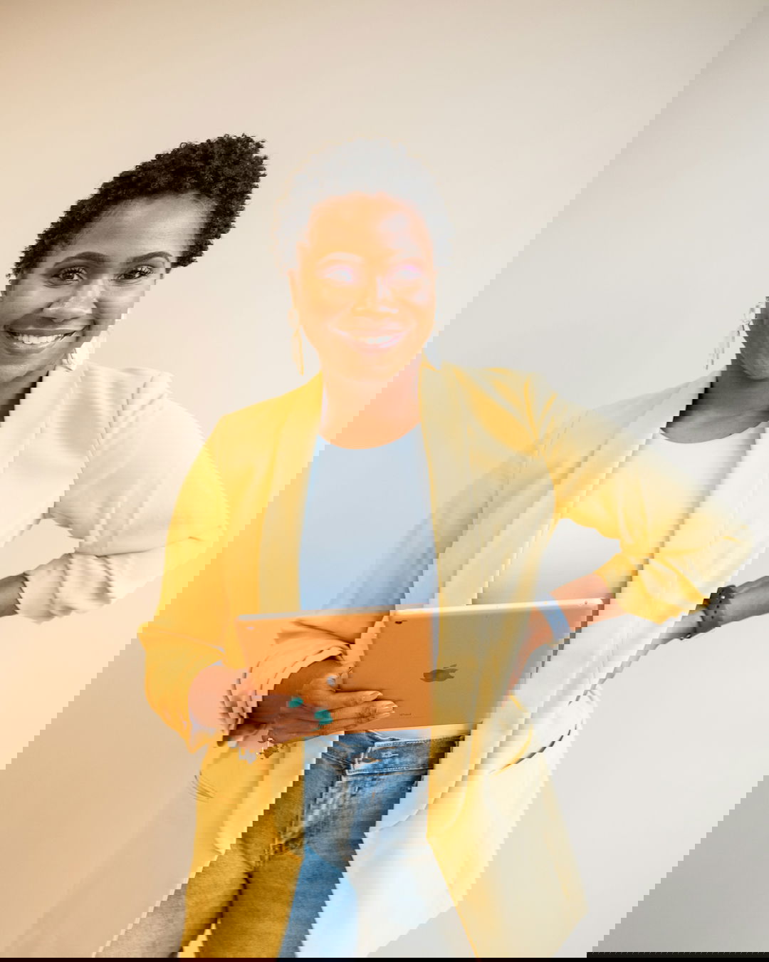 man in yellow blazer and blue denim jeans smiling